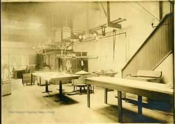 View of the interior of the Empire Laundry Company in Clarksburg showing tables and other equipment.