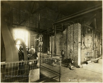 Man standing in the power plant of Empire Laundry.