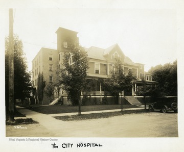 A car is parked in front of the City Hospital, in Elkins, West Virginia.