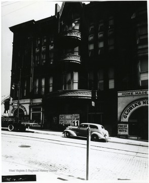The Watson Hotel with cars parked out front.