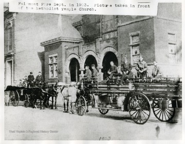 Firemen seated on horse drawn fire engines. 'Fairmont Fire Department in 1903. Picture taken in front of the Methodist Temple Church.'
