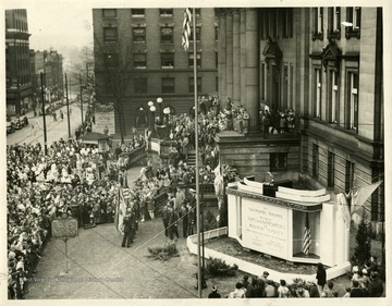 Groups of people gathered around the War Memorial at the Marion County Courthouse in Fairmont, West Virginia 