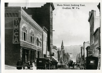 Postcard of buildings and carriages on Main Street looking East in Grafton, Taylor County, West Virginia.  