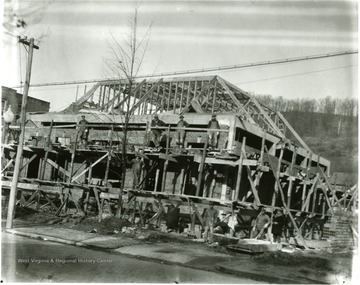 Workers stand on scaffolding around the Philippi Post Office while it is under construction.