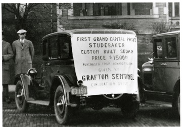 Man stands behind a custom built Studebaker, the First Grand Capital Prize Given by the Grafton Sentinel during a circulation drive.