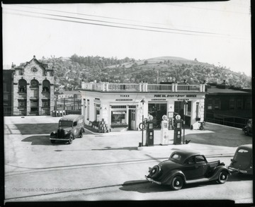 Several cars are parked in front of Pure Oil Gas Station on Main Street in Grafton, West Virginia.