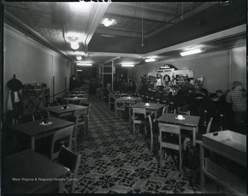 Interior view of a soda fountain store in Grafton, W. Va.  Young children sitting on bar stools, others standing at the entrance.