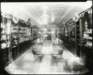 Interior view showing display cases and cabinets in the G. W. Loar Company Jewelry Store on Main Street in Grafton, W. Va.