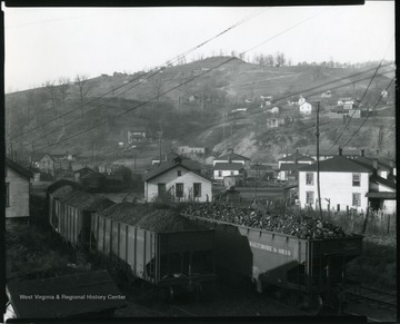 Several Baltimore and Ohio Coal Cars on driving on railroad tracks at an unidentified coal mining community near Grafton, West Virginia.