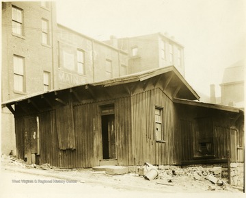 Large buildings surround a wooden building in Grafton, W. Va.