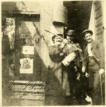James Murphy, Dr. A. S. Warder, Jr. and Lloyd Nuzum stand in a doorway.