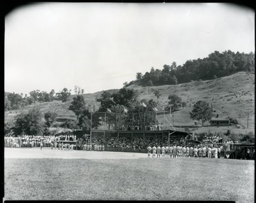Baseball team members participate in a pre-game ceremony.