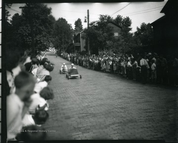 A crowd watches a go cart race in progress in Grafton, West Virginia.