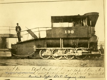 Man stands atop the first type of B&amp;O engine built circa 1850.