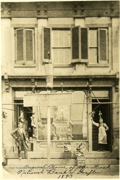 People stand on the stoop of the original building of the First National Bank in Grafton, W. Va.