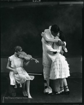 High school actors perform a romantic love scene from the play Prunella.