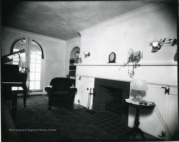 Living room with fireplace and piano.