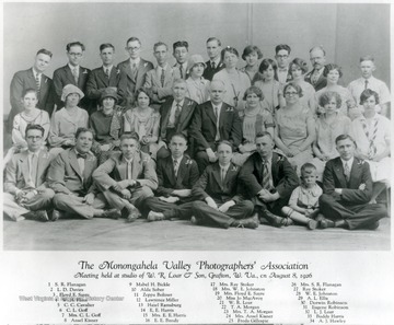 The Monongahela Valley Photographers' Association meeting held at studio of W.R. Loar and Son, Grafton, W. Va., on August 8, 1926.  1) S.R. Flanagan 2) L.D. Davies 3) Floyd E. Sayre 4) W.H. Flinn 5) C.C. Cavalier 6) C.L. Goff 7) Mrs. C.L. Goff 8) Ansel Kisner 9) Mabel H. Bickle 10) Alda Sober 11) Zeppa Boliner 12) Lawrence Miller 13) Hazel Ramsburg 14) E.E. Harris 15) Mrs. E. E. Harris 16) E.E. Bandy 17) Mrs. Ray Stoker 18) Mrs. W. E. Johnston 19) Mrs. Floyd E. Sayre 20) Miss Jo MacAvoy 21) W.R. Loar 22) T.A. Morgan 23) Mrs. T.A. Morgan 24) Mrs. Ansel Kisner 25) Frieda Gillespie 26) Mrs. S.R. Flanagan 27) Ray Stoker 28) W.E. Johnston 29) A.L. Ellis 30) Dorwin Robinson 31) Eugene Robinson 32) L.J. Loar 33) Buddy Harris 34) A.J. Hawley.