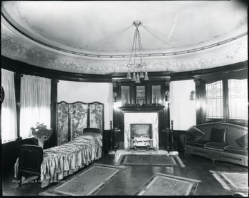 Interior view of room with a fireplace and furniture in the Bartlett home.