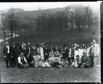 Group posing on a hillside opposite a church for a child's funeral in Grafton, West Virginia. 