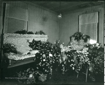 Flowers surround two coffins at an unidentified funeral parlor in Grafton, West Virginia.