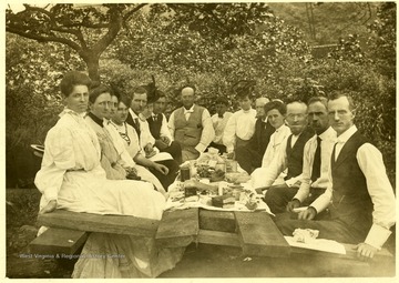 Loar family and others gathered around a table for a picnic, Grafton, W. Va. 