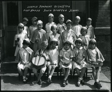 Members of the Juvenile Symphony Orchestra, First Grade, in South Grafton School, Grafton, West Virginia, pose with their instruments for a group portrait.