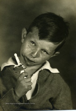 A young boy enjoys eating his ice cream.