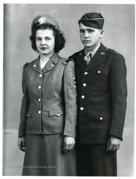 A soldier and nurse pose together for a portrait.