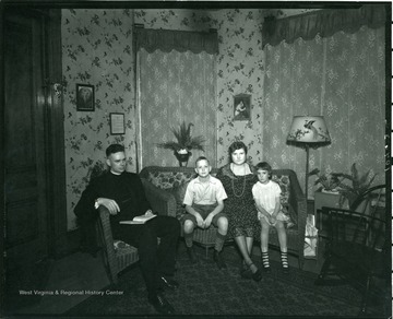 Rev. Roof and a family in their living room.