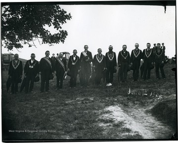 BLE members stand on a hillside.