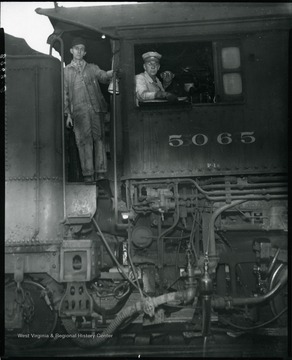 Three men in the cabin of a locomotive engine no. 5065. Grafton, W. Va.