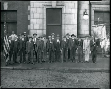 Group portrait of men of the RENO Post no. 7. Men at either end hold flags.