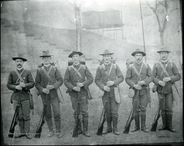 Six soldiers stand in a line for a group portrait.