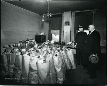 Two men look over Salvation Army food packages.