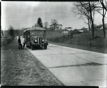 Two boys getting on a school bus in Grafton, W. Va.