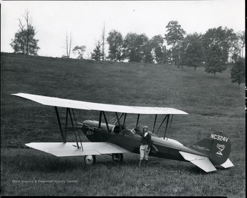 Pilot standing with a plane, Grafton, W. Va.