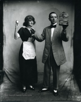 A woman and man are performing a magic act.