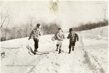 Three children run down a snow covered road near Harpers Ferry, W. Va.