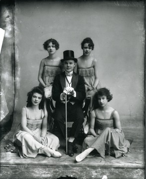 Four women entertainers surround one male entertainer.