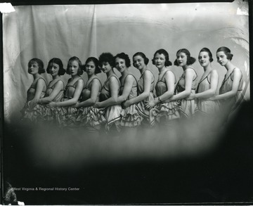 Eleven female dancers in a line.