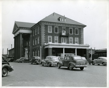 Several automobiles are parked in front of the C and O Railroad Depot in Huntington, West Virginia.