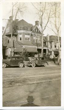 Two automobiles are parked in front of C.A. Northcott's House in Huntington, West Virginia.  Formerly John H. Russel home.