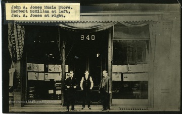 In front of John A. Jones Music Store are Herbert McMillan at left, and John A. Jones at right.