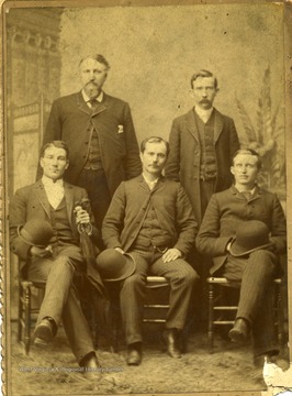 Three men sit and two men stand for this group portrait.