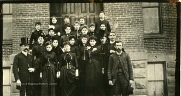 'In the early 90's .  Faculty of Oley School.  The gentleman in the plug hat is James M. Lee, then Huntington's school principal.  Also pictured, Lou Lallance, Anna Lallance, Dora Spongeuking, Jennie Elice Gitt, Libbie Johnston, Mayme Carrol, Sallie Peyton, Mrs. Staton, Effie Galliker, Maggie McGlothlina, Howdworth, Mrs. A. E. Vickers, Louis Wigal, Annie Ellei Fergusson 'Mr. J. Fergusson, Cora Frice.'