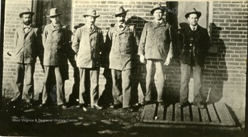 'Left to right: Lee D. Beuhring, R. F. Adams, Jonas W. Coffman, Jos. C. LeSage, James Russell, and A. W. Werninger, Assistant Postmaster.'