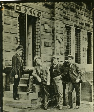 'Left to right: H. M. Adams, then postmaster of Huntington, Bob Johnston, Houston Fitch and Frank H. Tyree.'