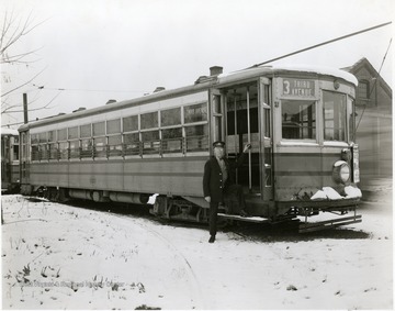 Driver stands at door to his Third Ave. trolley.