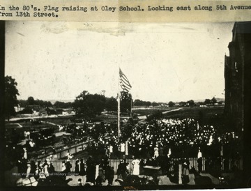 'In the 1880's. Flag raising at Oley School. Looking east along 5th Avenue from 13th Street.'